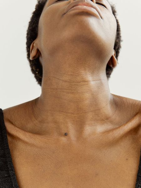 Woman in a peaceful meditative pose with a calm expression